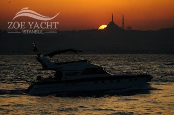 Image of a Bosphorus cruise boat at Istanbul sunset time in Turkey