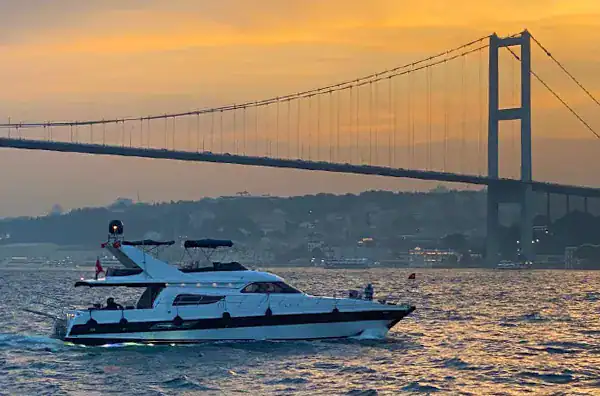 Image of a Bosphorus cruise boat at Istanbul sunset time in Turkey